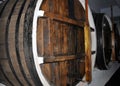 Rows of alcohol barrels in a warehouse of a factory for the production of cognac, whiskey, wine, brandy. Royalty Free Stock Photo