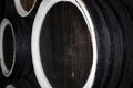 Rows of alcohol barrels in a warehouse of a factory for the production of cognac, whiskey, wine, brandy. Royalty Free Stock Photo