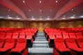 Rows of arm-chairs are in empty hall