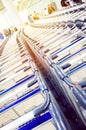 Rows of baggage trolleys in the building of the airport in retro style