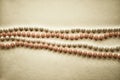 Rows of beads on a light background, tinted black gold. Gift for March 8, Women`s Day, Wedding, Valentine`s Day, Birthday.