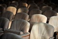 Rows of beige velvet armchairs