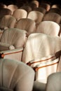 Rows of beige velvet armchairs