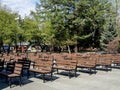 rows of benches in the city park near the stage on a spring morning Royalty Free Stock Photo