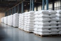 Rows of big white sacks at large warehouse in modern factory Royalty Free Stock Photo