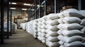 Rows of big white sacks at large warehouse in modern factory Royalty Free Stock Photo