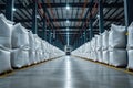 Rows of big white sacks at large warehouse in modern factory Royalty Free Stock Photo