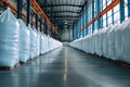 Rows of big white sacks at large warehouse in modern factory Royalty Free Stock Photo