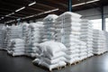 Rows of big white sacks at large warehouse in modern factory Royalty Free Stock Photo