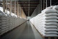 Rows of big white sacks at large warehouse in modern factory Royalty Free Stock Photo