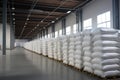 Rows of big white sacks at large warehouse in modern factory Royalty Free Stock Photo