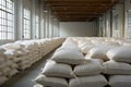 Rows of big white sacks at large warehouse in modern factory Royalty Free Stock Photo