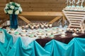 Rows of birthday cupcake with butter white and blue cream icing on a wooden stand