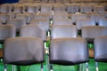 Rows of black chairs in the hall on a green background Royalty Free Stock Photo