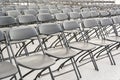 Rows of black folding chairs empty Royalty Free Stock Photo