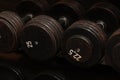 Rows of black iron dumbbells on a rack in gym, black Royalty Free Stock Photo