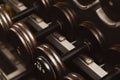 Rows of black iron dumbbells on a rack in gym, black Royalty Free Stock Photo