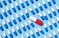 Rows of Blue Pills and One Red Pill