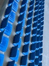rows of blue seats for spectators in the stadium Royalty Free Stock Photo