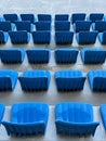 rows of blue seats for spectators in the stadium Royalty Free Stock Photo