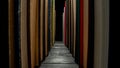 Rows of books with colored covers arranged on bookshelf in library. Old books with red, green and blue covers on Royalty Free Stock Photo