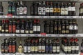 Moscow, Russia, 04/29/2020: Rows of bottled alcohol of different kinds at a supermarket. Multiple colors, price tags