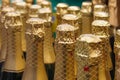 A rows of bottles with champagne in gold foil Royalty Free Stock Photo