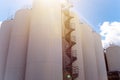 Rows of brewing tanks against the sky. Industrial beer production