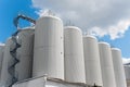 Rows of brewing tanks against the sky. Industrial beer production.