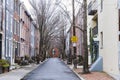 Rows of brownstone apartment buildings in Center City with windows, stoops and plant bushes in Pennsylvania