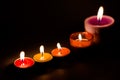 Rows of burning colorful candles