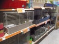 Rows of cages in a pet store.