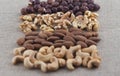 Rows of cashew nuts, almonds, walnuts and hazelnuts on a burlap fabric. Selective focus on walnuts.