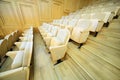 Rows of chairs inside big light hall