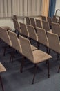 Rows of chairs made of metal and brown velour upholstery are empty in the building Royalty Free Stock Photo