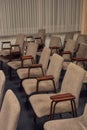 Rows of chairs made of metal and brown velour upholstery are empty in the building Royalty Free Stock Photo