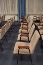 Rows of chairs made of metal and brown velour upholstery are empty in the building Royalty Free Stock Photo