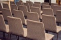 Rows of chairs made of metal and brown velour upholstery are empty in the building Royalty Free Stock Photo