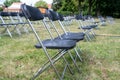 Rows of chairs at an open air event with wide spacing to protect the audience from covid-19 infection, selected focus