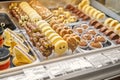 Rows of chocolate cakes and desserts in the window of a pastry shop. Showcase desserts in an Italian cafe or trattoria.