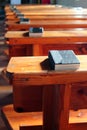 Rows of church benches with bibles. Empty wooden pews. Selective focus Royalty Free Stock Photo
