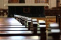 Rows of church benches. Sunlight reflection on polished wooden pews Royalty Free Stock Photo