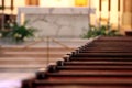 Rows of church benches. Sunlight reflection on polished wooden pews. Selective focus