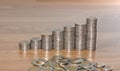 Rows of coin stacks on wooden floor. banking concept. Royalty Free Stock Photo