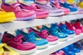 rows of colorful childrens shoes on white display shelves Royalty Free Stock Photo