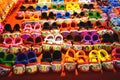 Rows of colorful hand made baby shoes in market