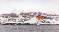Rows of colorful Inuit living houses of Sisimiut, on the snow rocks