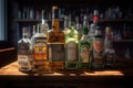 Rows of colorful liquor bottles on illuminated shelves behind a wooden bar counter Royalty Free Stock Photo