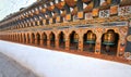 Rows of colorful religious prayer wheels in Paro Rinpung Dzong. Royalty Free Stock Photo