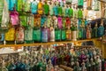 Rows of coloured glass antique soda bottles lined up at a flea market in San Telmo, Buenos Aires, Argentina